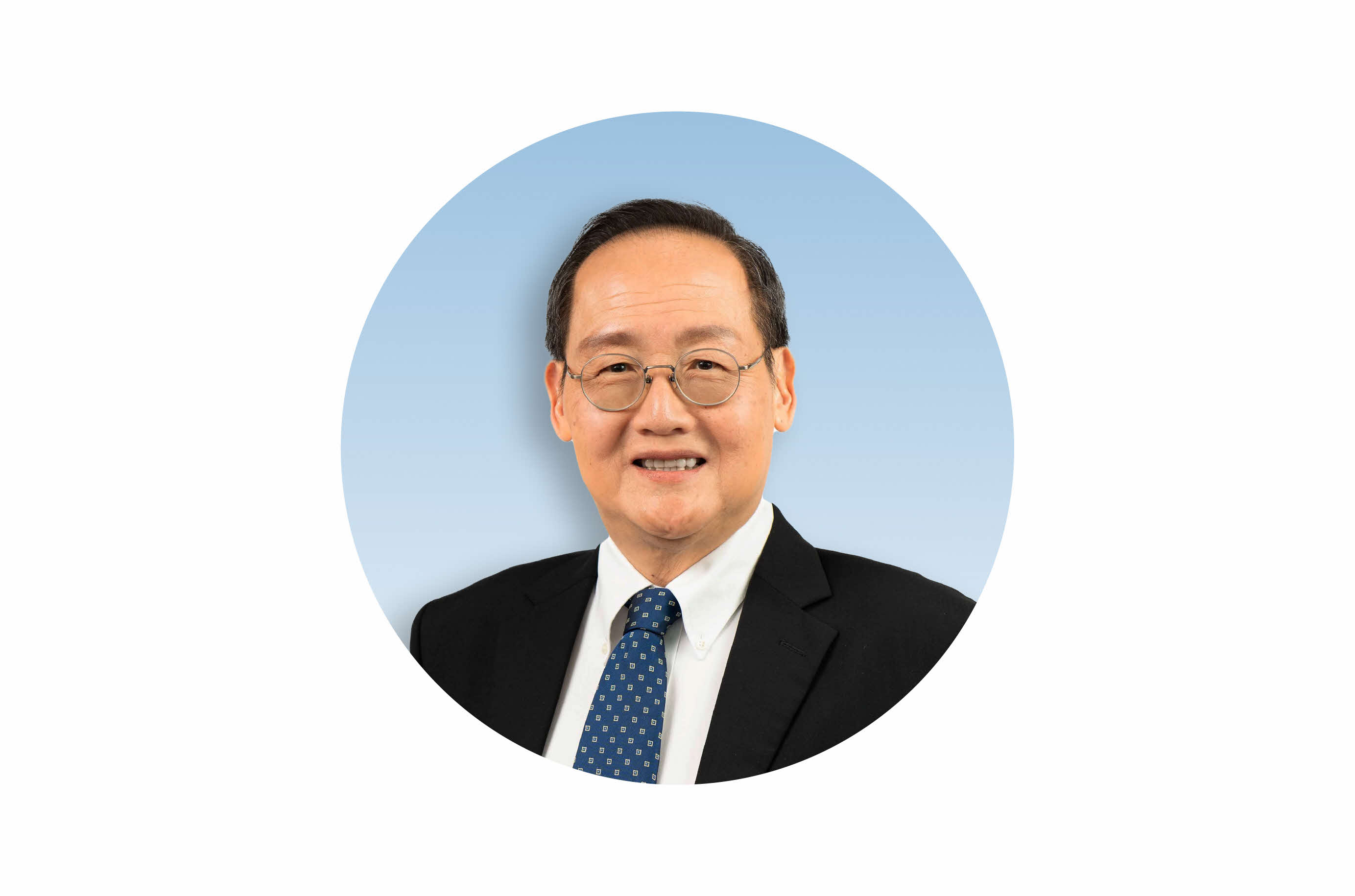 Second Minister for Trade and Industry, Dr Tan See Leng in in black suit with blue tie smiling against a green circular